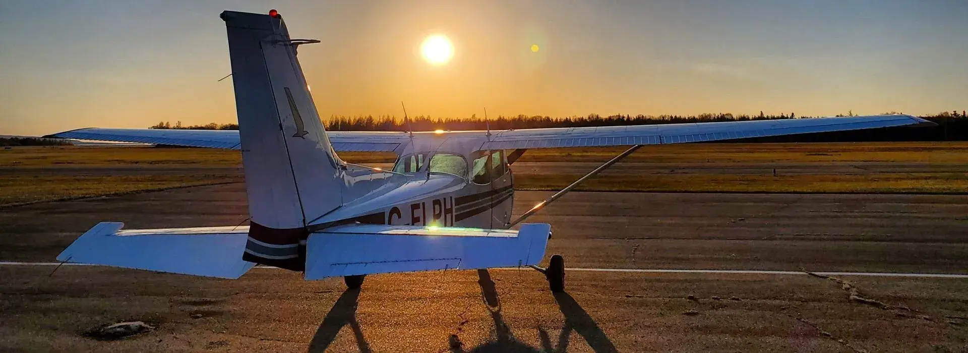 Small plane taxiing to side of runway